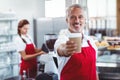 Happy barista giving take-away cup Royalty Free Stock Photo