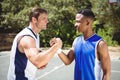 Happy basketball player holding hands in court Royalty Free Stock Photo