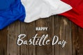 Happy Bastille Day. 14th July. Flag of France on a wooden background with text. Celebrating a public holiday. Independence Day. Royalty Free Stock Photo