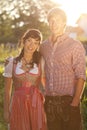 Happy bavarian couple in the evening sun