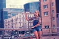 Happy beaming girl waving her friends while meeting them in the city center