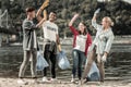 Happy beaming volunteers giving high five to each other after completing the tasks