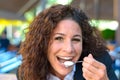 Happy beaming woman eating cream