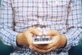 Happy bearded African businessman using phone while sitting on sofa Royalty Free Stock Photo