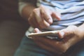 Happy bearded African businessman using phone while sitting on sofa Royalty Free Stock Photo