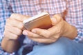 Happy bearded African businessman using phone while sitting on sofa Royalty Free Stock Photo