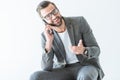 happy bearded businessman in gray suit gesturing and talking on smartphone Royalty Free Stock Photo