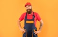 happy bearded deliveryman in work clothes on yellow background