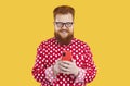 Happy fat man uses his mobile phone for online shopping, chatting and using mobile applications. Royalty Free Stock Photo