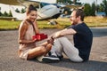 Surprised brunette female person looking at gift box Royalty Free Stock Photo