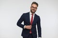 Happy bearded man with glasses fixing and unbuttoning suit Royalty Free Stock Photo