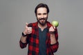 Happy bearded man hold Apple and looking at Camera Royalty Free Stock Photo