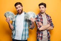 Happy bearded man holding money and looking at the camera Royalty Free Stock Photo