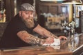 Happy bearded man standing at bar counter Royalty Free Stock Photo