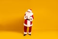 Happy bearded real Santa Claus with headphones dancing and listening music from mobile phone. Yellow studio background. Christmas Royalty Free Stock Photo