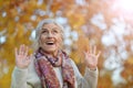 Happy beautifil elderly woman posing in autumn park Royalty Free Stock Photo