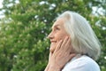 Portrait of happy beautifil elderly woman posing in summer park Royalty Free Stock Photo