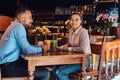 Happy beautiful African-American couple in love having a great time together in a restaurant at their dating, an Royalty Free Stock Photo