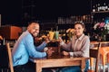 Happy beautiful African-American couple in love having a great time together in a restaurant at their dating, an Royalty Free Stock Photo