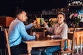 Happy beautiful African-American couple in love having a great time together in a restaurant at their dating, an Royalty Free Stock Photo