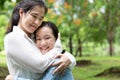 Happy beautiful asian adult woman and cute child girl with hugging and smiling in summer,love of mother with her little daughter Royalty Free Stock Photo