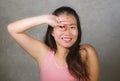 Happy and beautiful Asian Chinese teenager woman emulating fingers knot gesture of football player goal celebration that became a Royalty Free Stock Photo