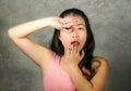 Happy and beautiful Asian Chinese teenager woman emulating fingers knot gesture of football player goal celebration that became a Royalty Free Stock Photo