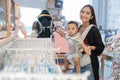 asian mother with her toddler boy shopping in the baby shop Royalty Free Stock Photo