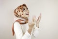 Happy beautiful Asian Muslim girl wearing a headscarf praying to God Royalty Free Stock Photo