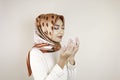 Happy beautiful Asian Muslim girl wearing a headscarf praying to God Royalty Free Stock Photo