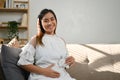 Happy and beautiful Asian pregnant woman touching her belly, sitting on sofa.. motherhood Royalty Free Stock Photo