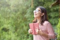 Happy Beautiful Asian woman holding book. Royalty Free Stock Photo