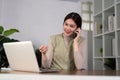 Happy beautiful asian woman relaxing using of laptop computer while sitting on table. Young creative girl working and Royalty Free Stock Photo
