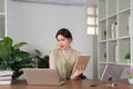 Happy beautiful asian woman relaxing using of laptop computer while sitting on table. Young creative girl working and Royalty Free Stock Photo