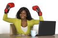 Happy beautiful black afro American woman in boxing gloves smiling cheerful working at office computer desk posing as successful e Royalty Free Stock Photo