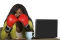 Happy beautiful black afro American woman in boxing gloves smiling cheerful working at office computer desk posing as successful e Royalty Free Stock Photo