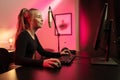 Happy and Beautiful Blonde Gamer Girl Playing Online Video Game on Her Personal Computer. Royalty Free Stock Photo