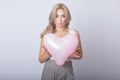 Happy beautiful blonde woman holding pink heart balloon Royalty Free Stock Photo