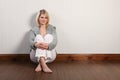 Happy beautiful blonde woman in knitted cardigan