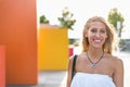 Happy beautiful blonde woman smiling looking at the camera and p Royalty Free Stock Photo