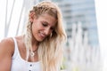 Happy beautiful blonde woman smiling looking at the camera and p Royalty Free Stock Photo