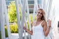 Happy beautiful blonde woman smiling looking at the camera and p Royalty Free Stock Photo