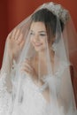 Happy beautiful bride under veil closeup. Beautiful bride shows makeup Royalty Free Stock Photo