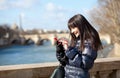 Happy beautiful brunette tourist sending an sms Royalty Free Stock Photo