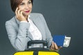 Happy beautiful business woman with passport and baggage going on a trip. Vacation and entertainment. Search for places to travel Royalty Free Stock Photo