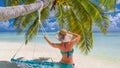 Happy beautiful carefree woman enjoying sunshine on the beach. Young woman in red pink bikini in white sandy beach at Maldive Royalty Free Stock Photo