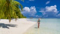 Happy beautiful carefree woman enjoying sunshine on the beach. Young woman in red pink bikini in white sandy beach at Maldive Royalty Free Stock Photo