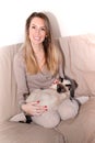 Happy beautiful cat and young woman relaxing on the couch at home happy smiling Royalty Free Stock Photo