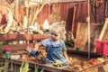 Happy beautiful child girl playing alone outdoors on playground with toy cars in sandbox in countryside symbolizing childhood life Royalty Free Stock Photo