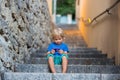 Happy beautiful children, playing on stone stairs in old town, taking pictures Royalty Free Stock Photo